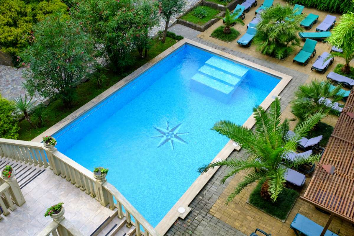 Pool service in a drought-regulated region — close-up of pool water surface during a season of restricted refill and water-use rules