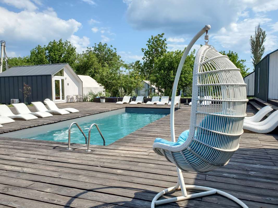 Hiring a pool service technician — residential backyard pool ready for the kind of weekly visit a new hire will be trained to deliver